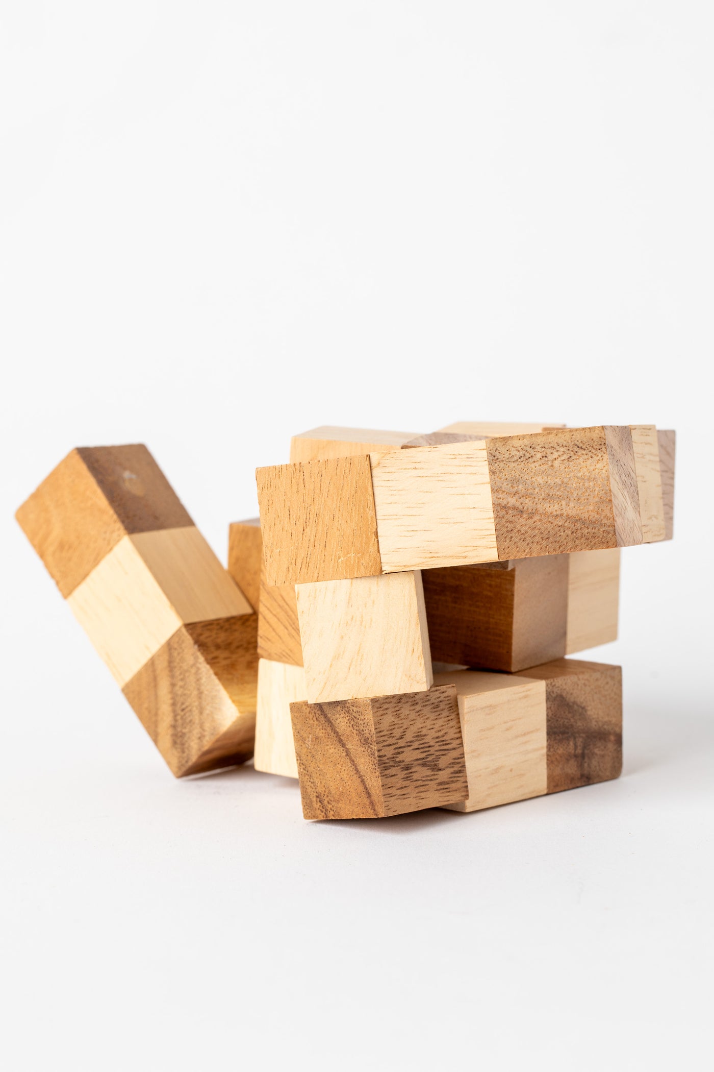 Wooden cube puzzle in mid-solve position highlighting craftsmanship and texture of natural wood.