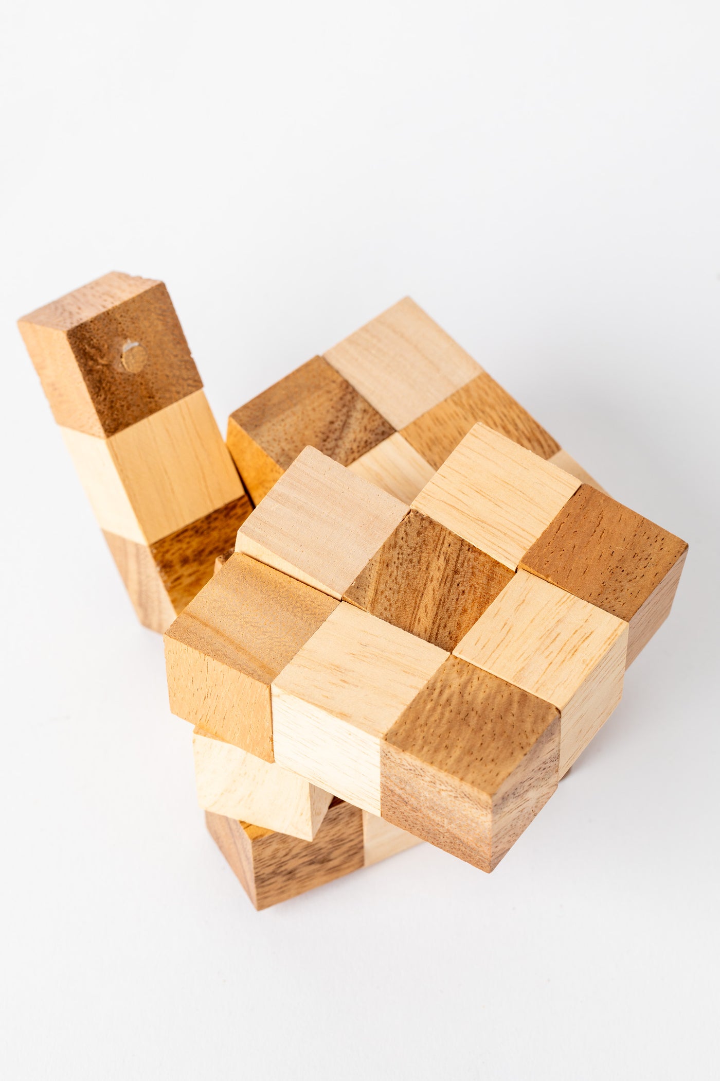Wooden cube puzzle in mid-solve position highlighting craftsmanship and texture of natural wood.