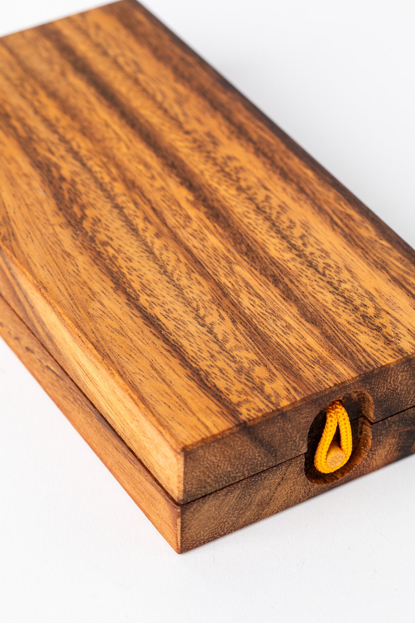 Closed wooden mancala game board with visible wood grain texture — handmade decorative game piece.