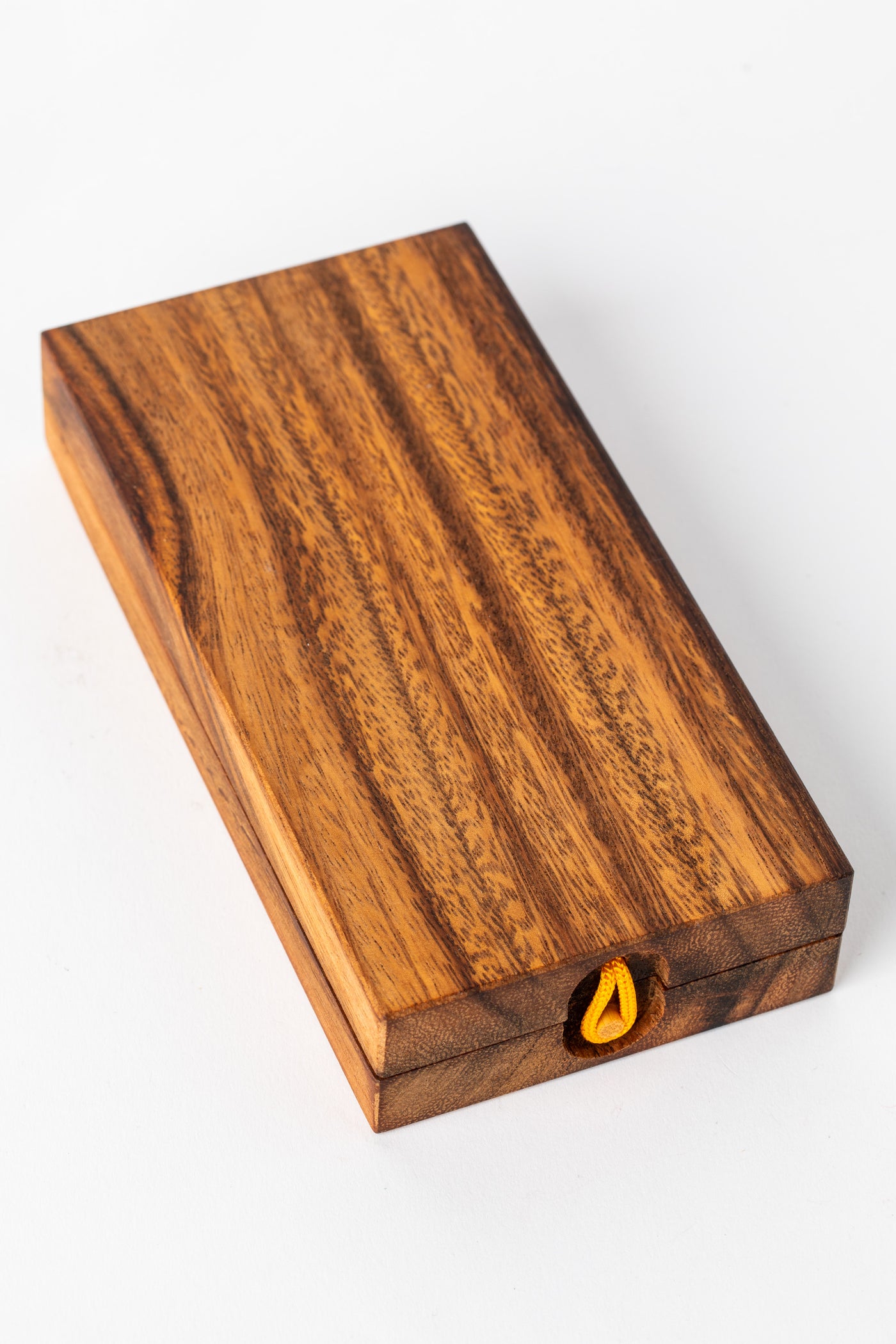 Closed wooden mancala game board with visible wood grain texture — handmade decorative game piece.