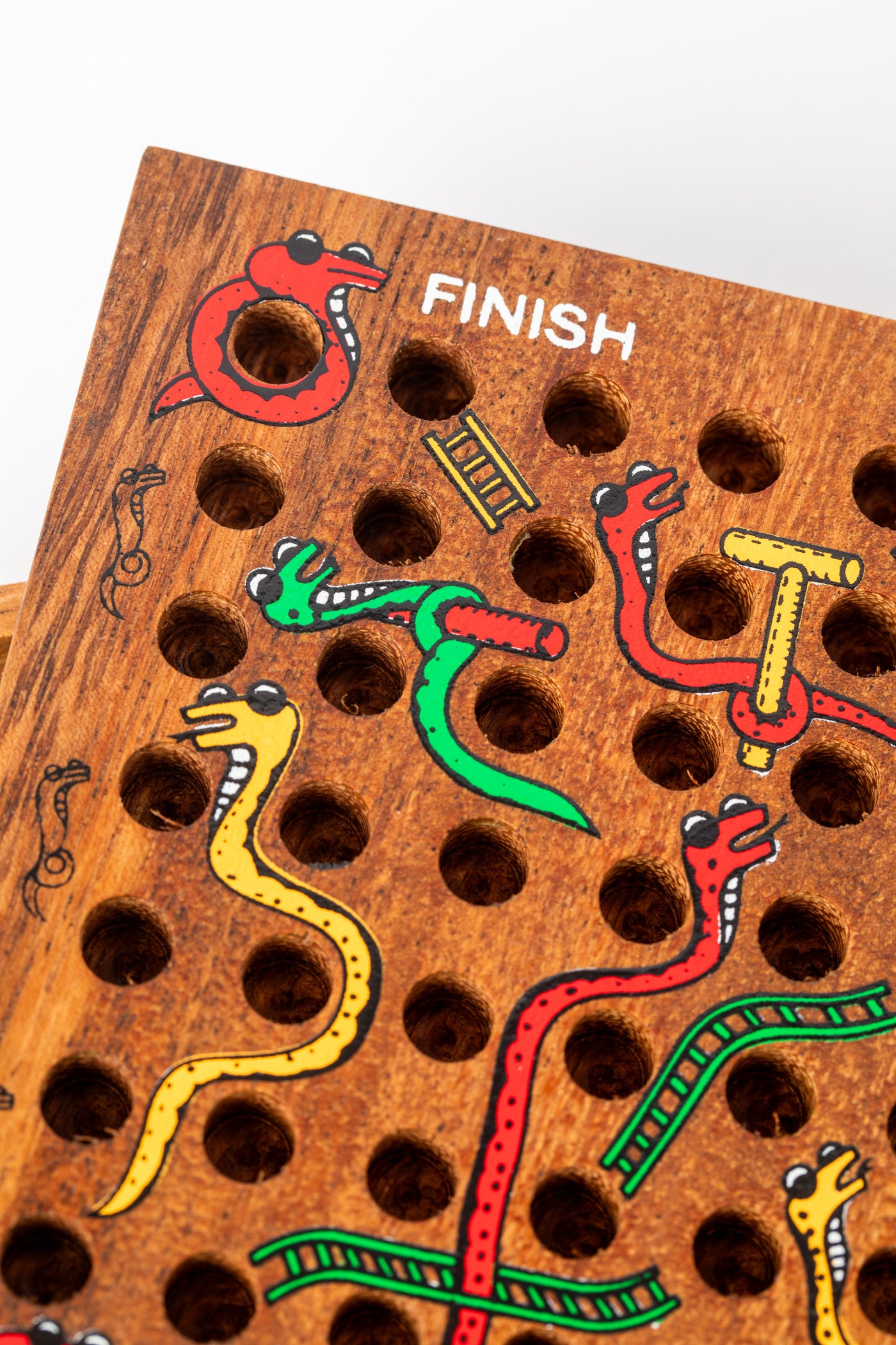 Finish section of Slips and Strides wooden game with colorful painted snakes — handmade game for kids and families.