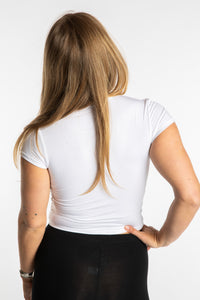 Sophie is wearing the S/M White Chara Crew Neck Top