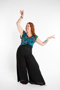 Maggie is wearing the Blue Ocean Tie Dye Cinch Crop Top and Black Penny Lane Pants