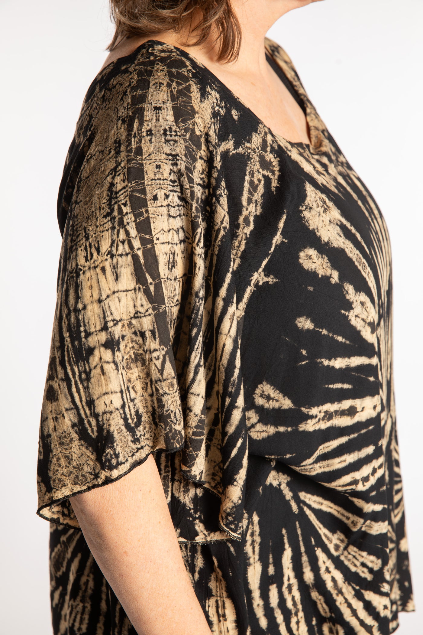 Betty is wearing the Black and White Benya Tie Dye Butterfly Top
