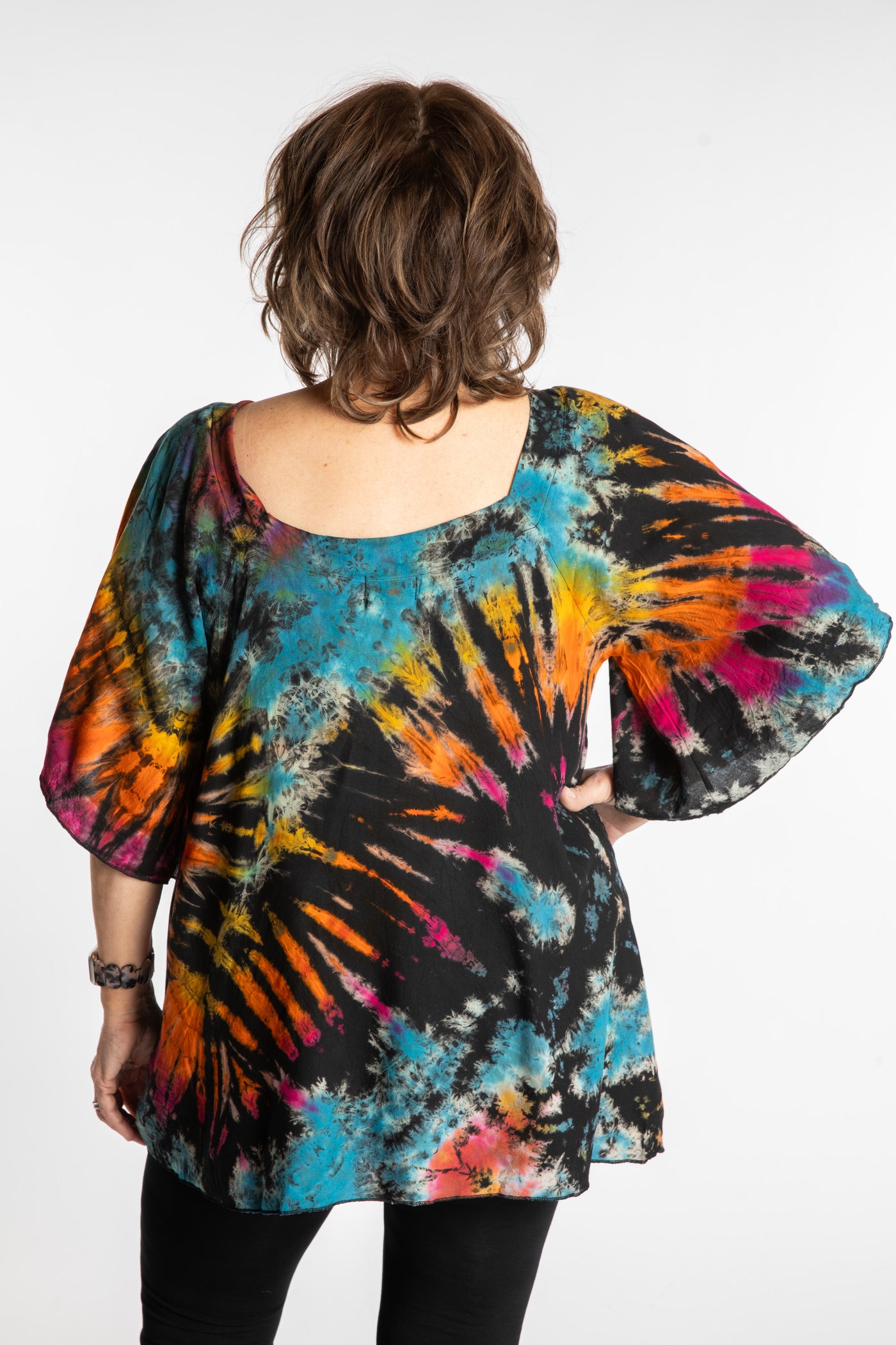 Betty is wearing the Black Rainbow Benya Tie Dye Butterfly Top