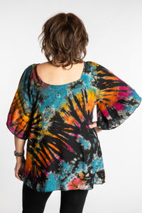Betty is wearing the Black Rainbow Benya Tie Dye Butterfly Top