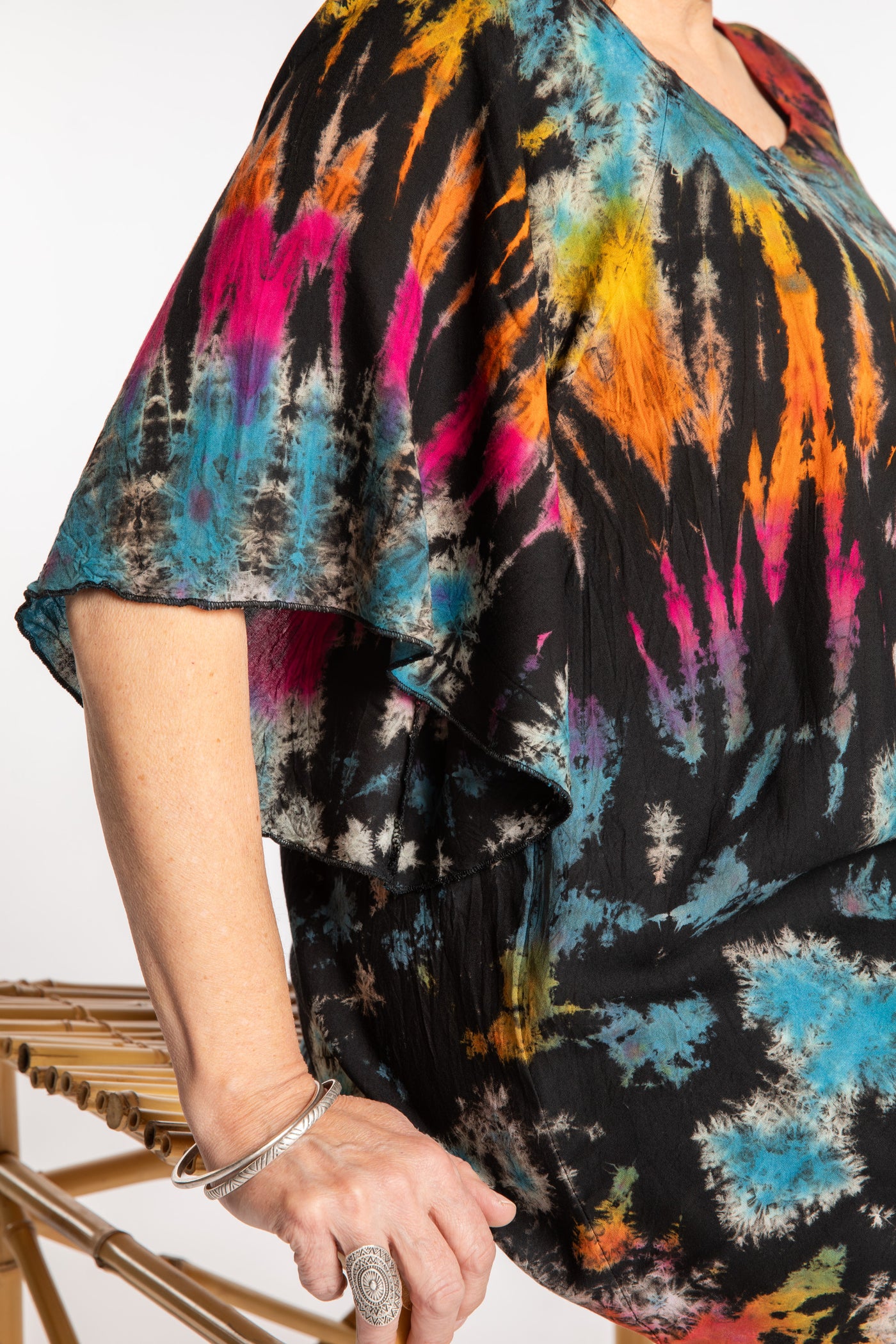 Betty is wearing the Black Rainbow Benya Tie Dye Butterfly Top