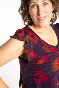 Betty is wearing the Purple Eggplant Tie Dye Flutter Sleeve Top