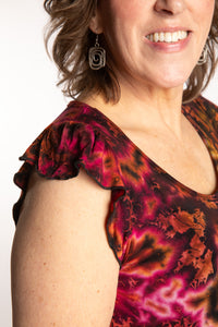 Betty is wearing the Orange Sunset Tie Dye Flutter Sleeve Top
