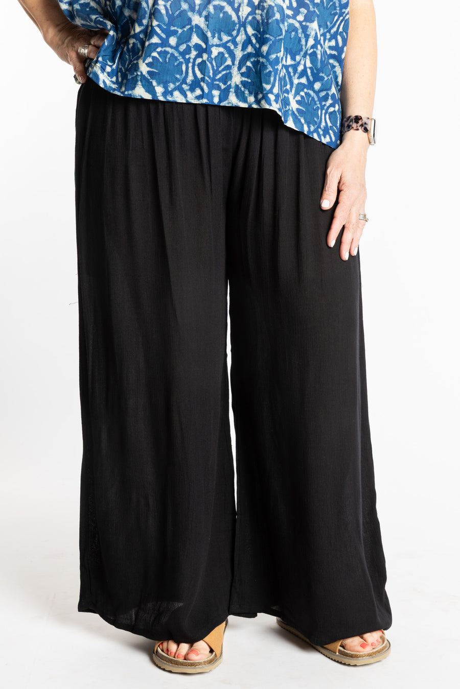 Betty is wearing the M/L Black Penny Lane bohemian wide leg Pants