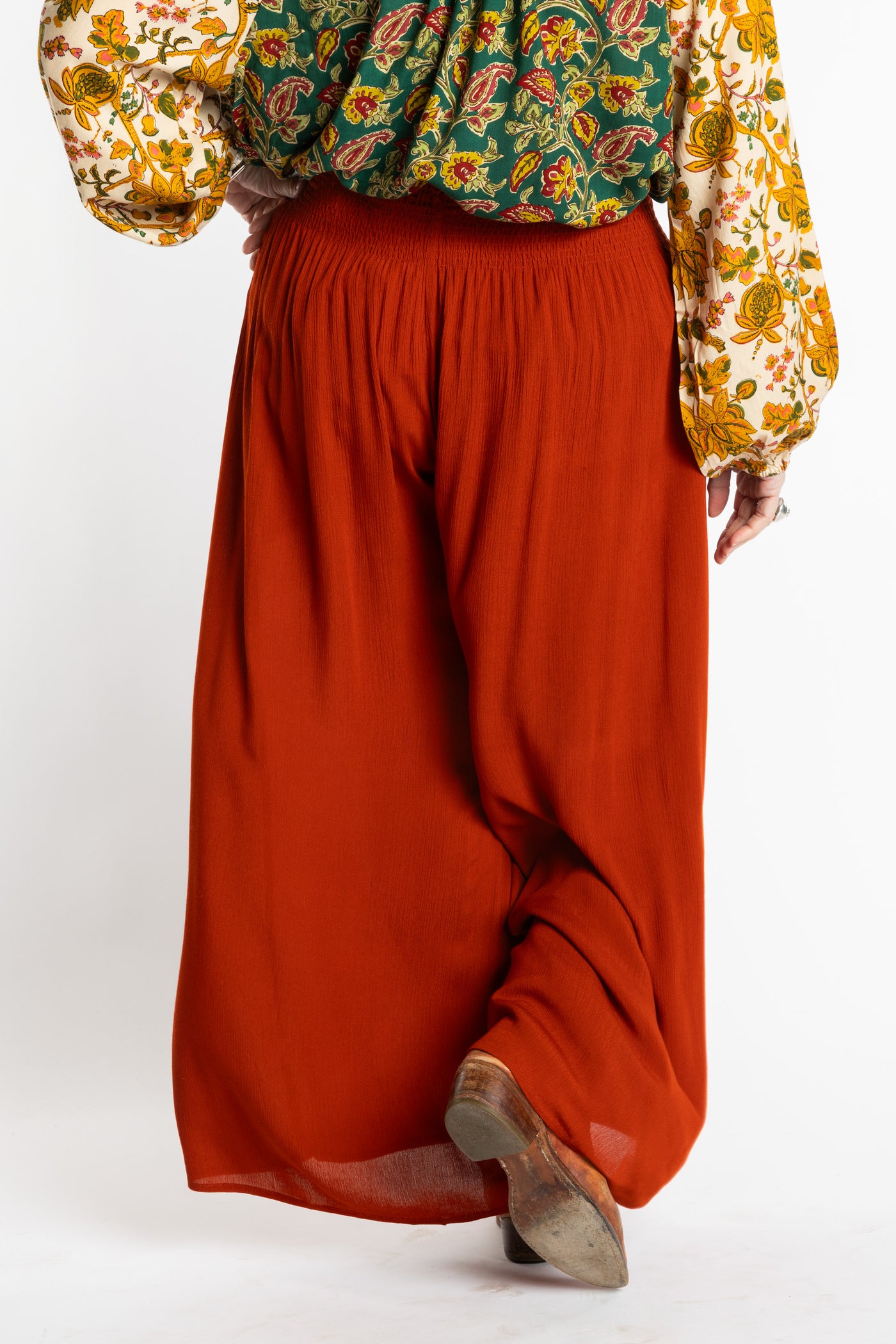 Susan is wearing the M/L Rust Penny Lane bohemian wide leg Pants