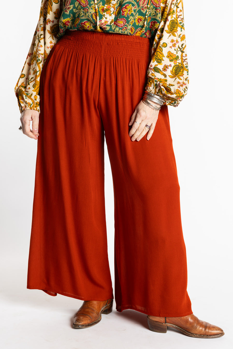 Susan is wearing the M/L Rust Penny Lane bohemian wide leg Pants