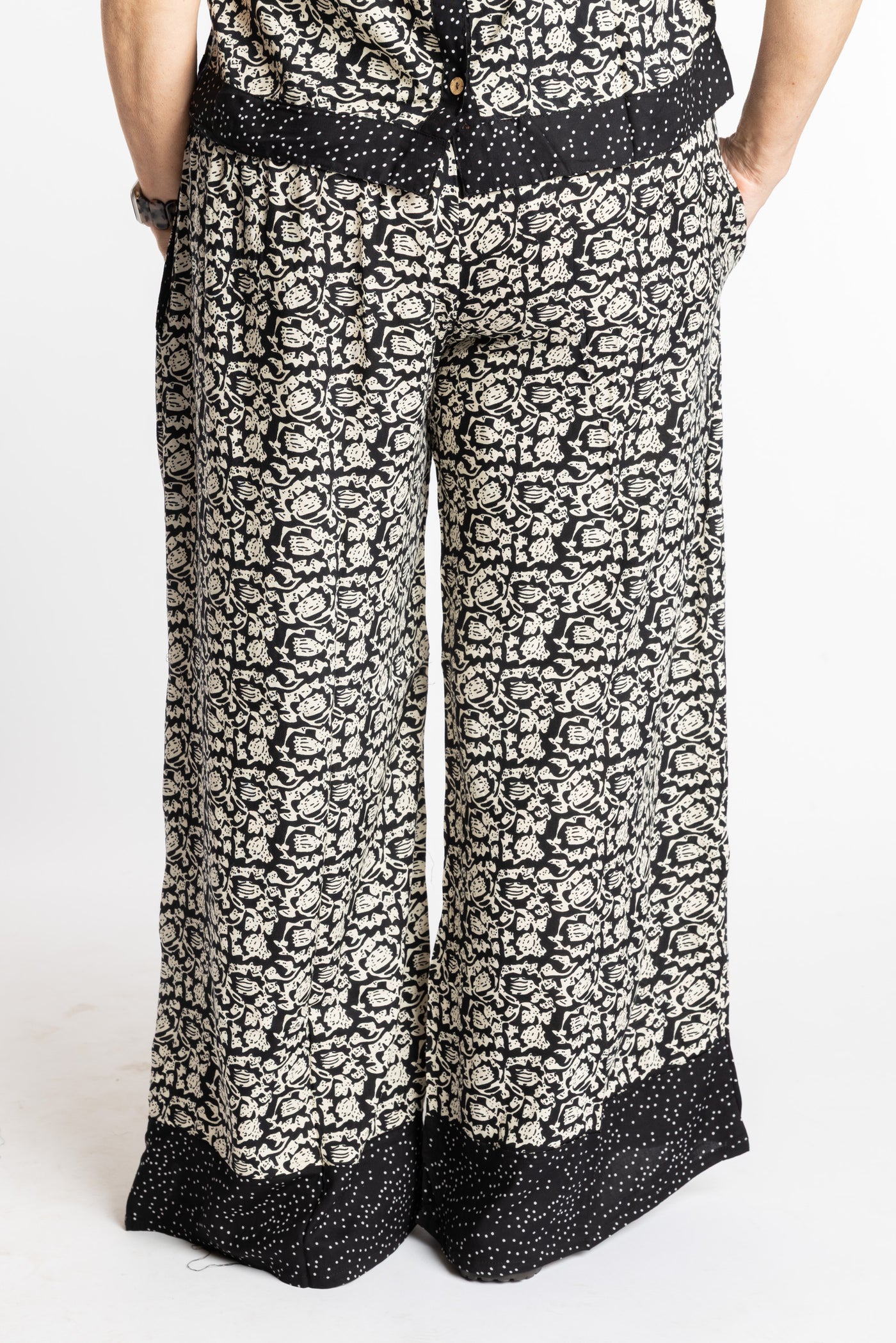 Betty wearing size M/L Black Primrose floral Penny Lane contrast hem wide leg pants