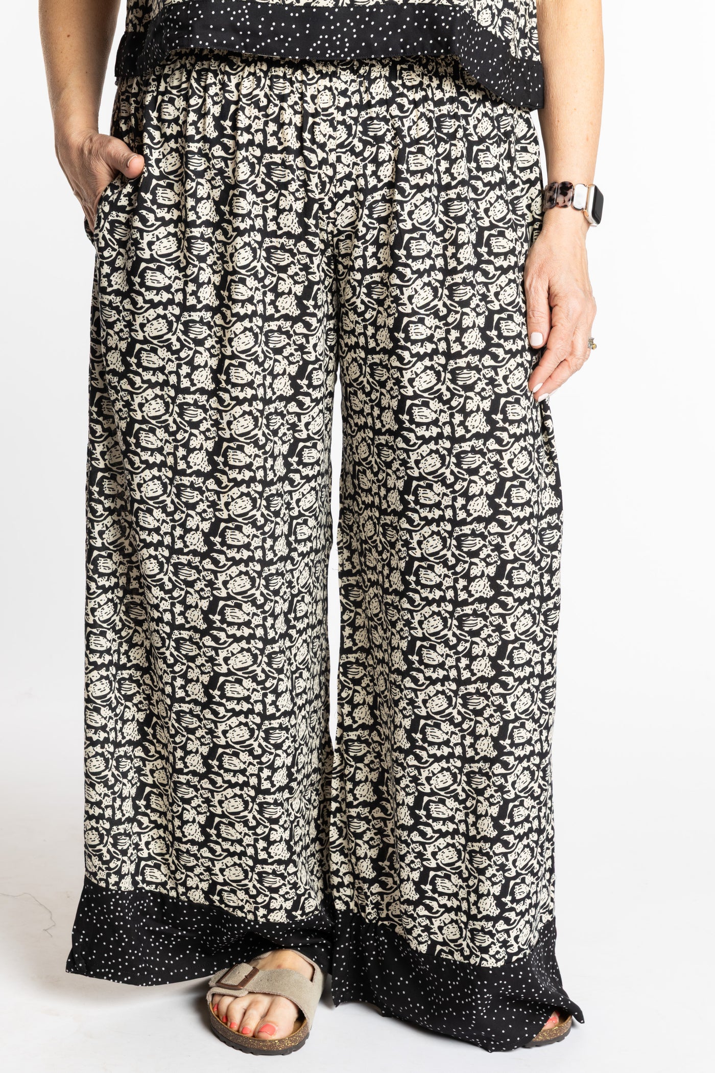 Betty wearing size M/L Black Primrose floral Penny Lane contrast hem wide leg pants