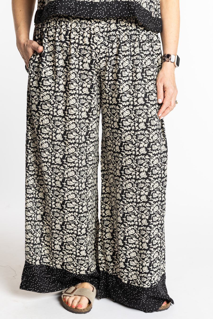 Betty wearing size M/L Black Primrose floral Penny Lane contrast hem wide leg pants