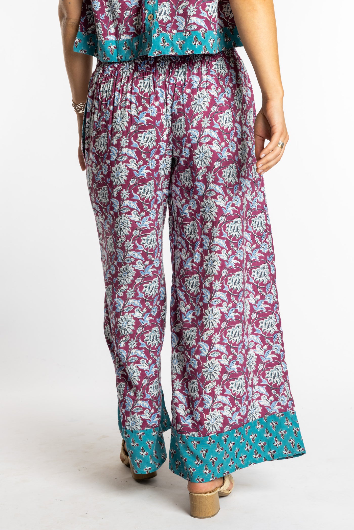 Sophie wearing size S/M Burgundy floral Penny Lane contrast hem wide leg pants with sleeveless boho top