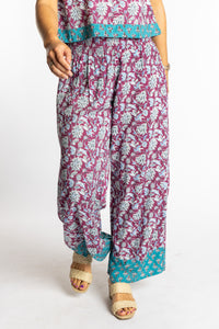 Sophie wearing size S/M Burgundy floral Penny Lane contrast hem wide leg pants with sleeveless boho top