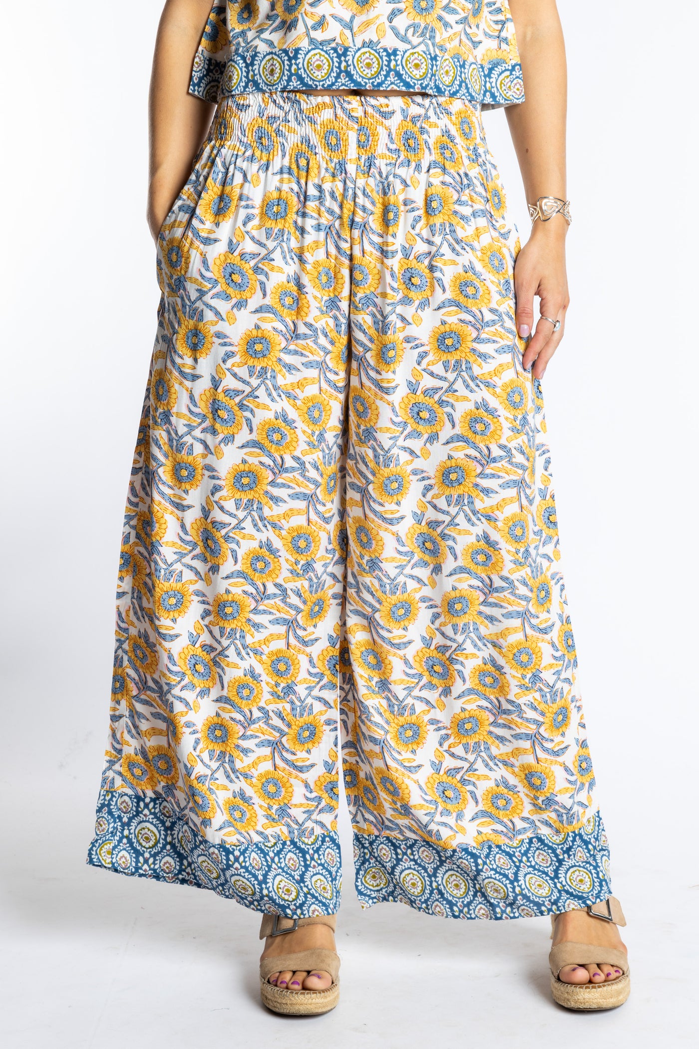Sophie wearing size S/M Sunflower floral Penny Lane contrast hem wide leg pants with sleeveless boho top