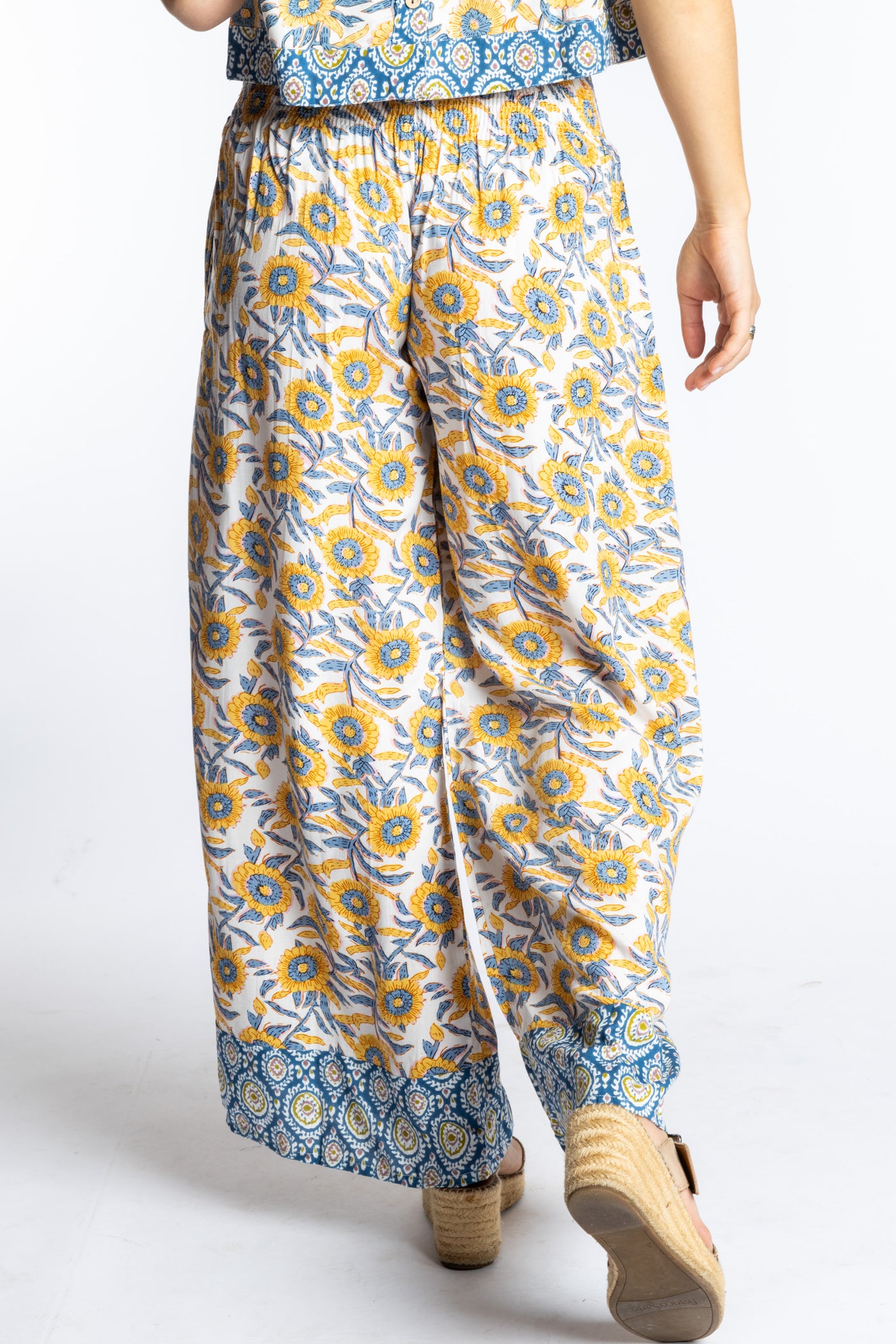 Sophie wearing size S/M Sunflower floral Penny Lane contrast hem wide leg pants with sleeveless boho top