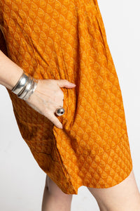 Susan is wearing the M/L Yellow Honeydrop Boho Cotton Mini Printed Dress
