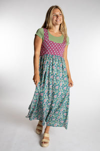 Sophie wearing the S/M aqua floral Flora Fusion maxi dress with pine green kyra cross back crop top
