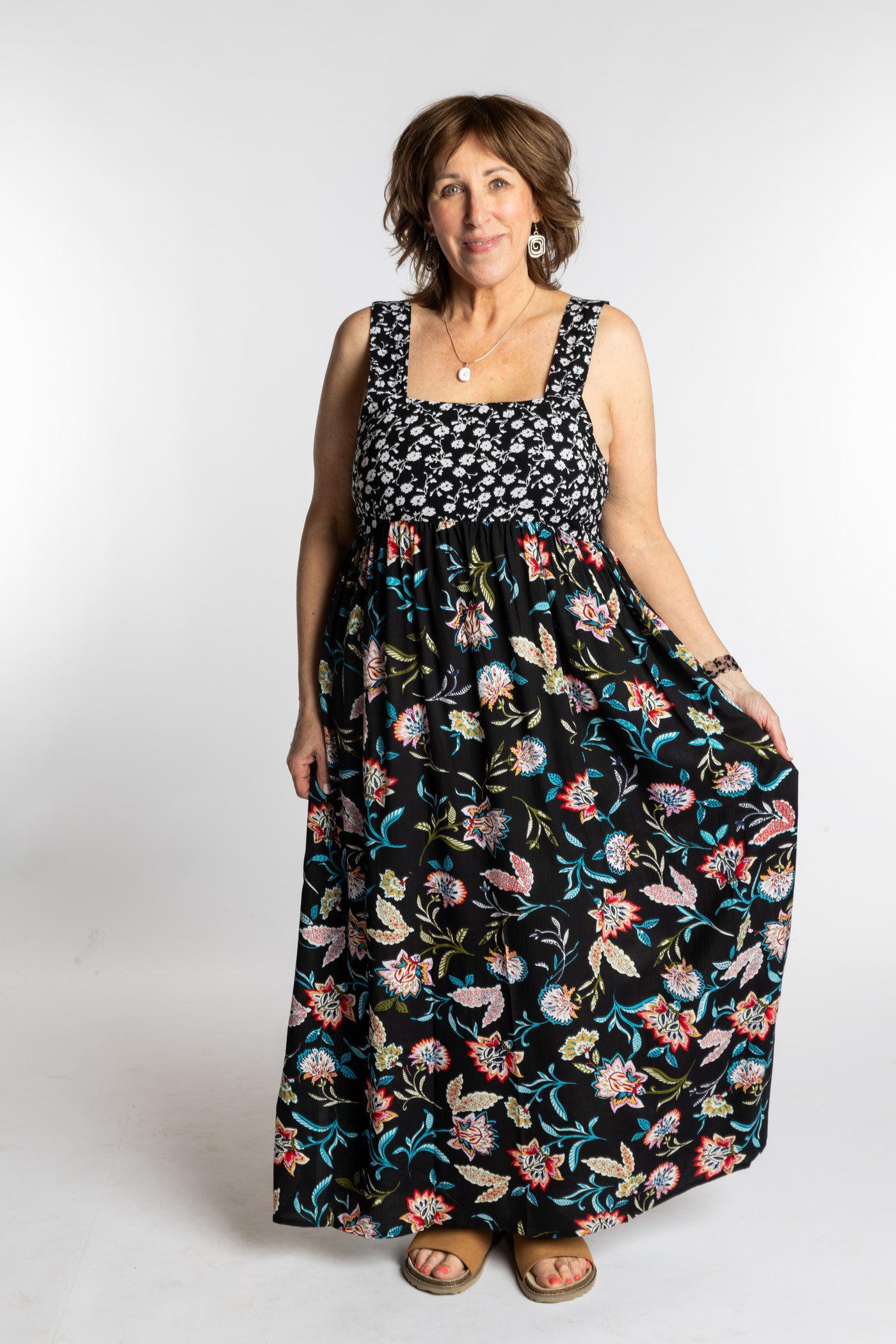 Betty wearing the L/XL black floral Flora Fusion maxi dress with smocked bodice and flowy skirt