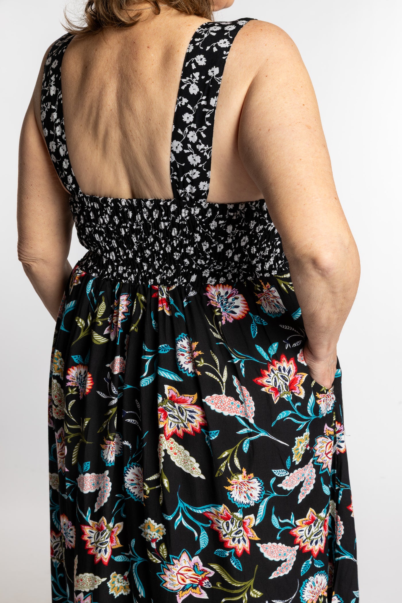 Betty wearing the L/XL black floral Flora Fusion maxi dress with smocked bodice and flowy skirt