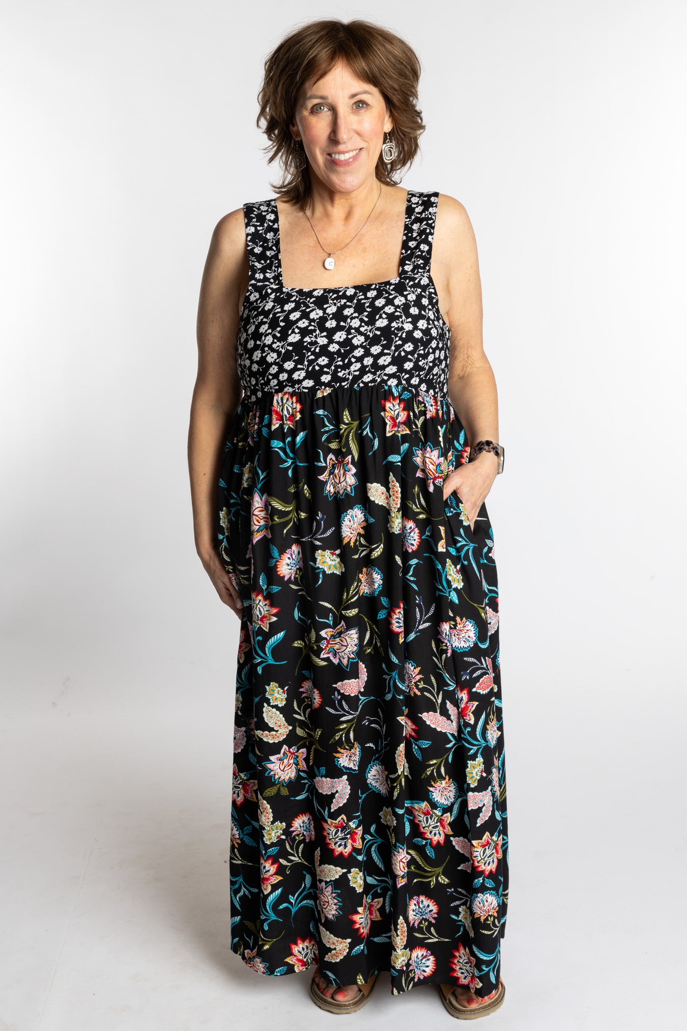 Betty wearing the L/XL black floral Flora Fusion maxi dress with smocked bodice and flowy skirt