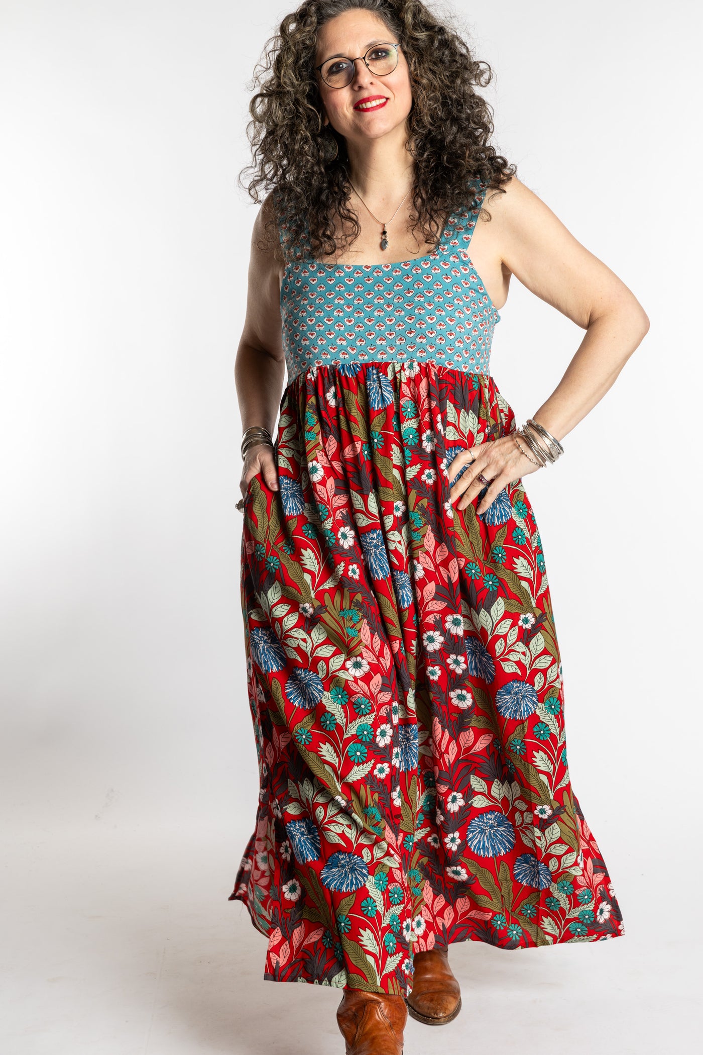 Susan wearing size M/L red floral Flora Fusion maxi dress with teal contrast top 