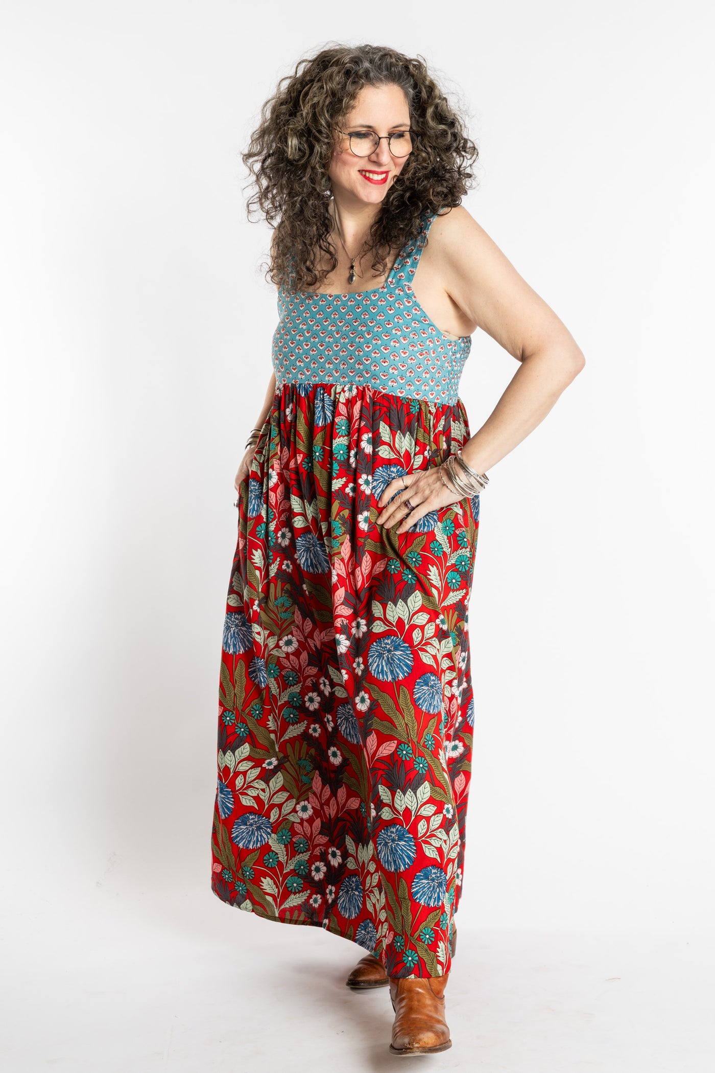 Susan wearing size M/L red floral Flora Fusion maxi dress with teal contrast top 