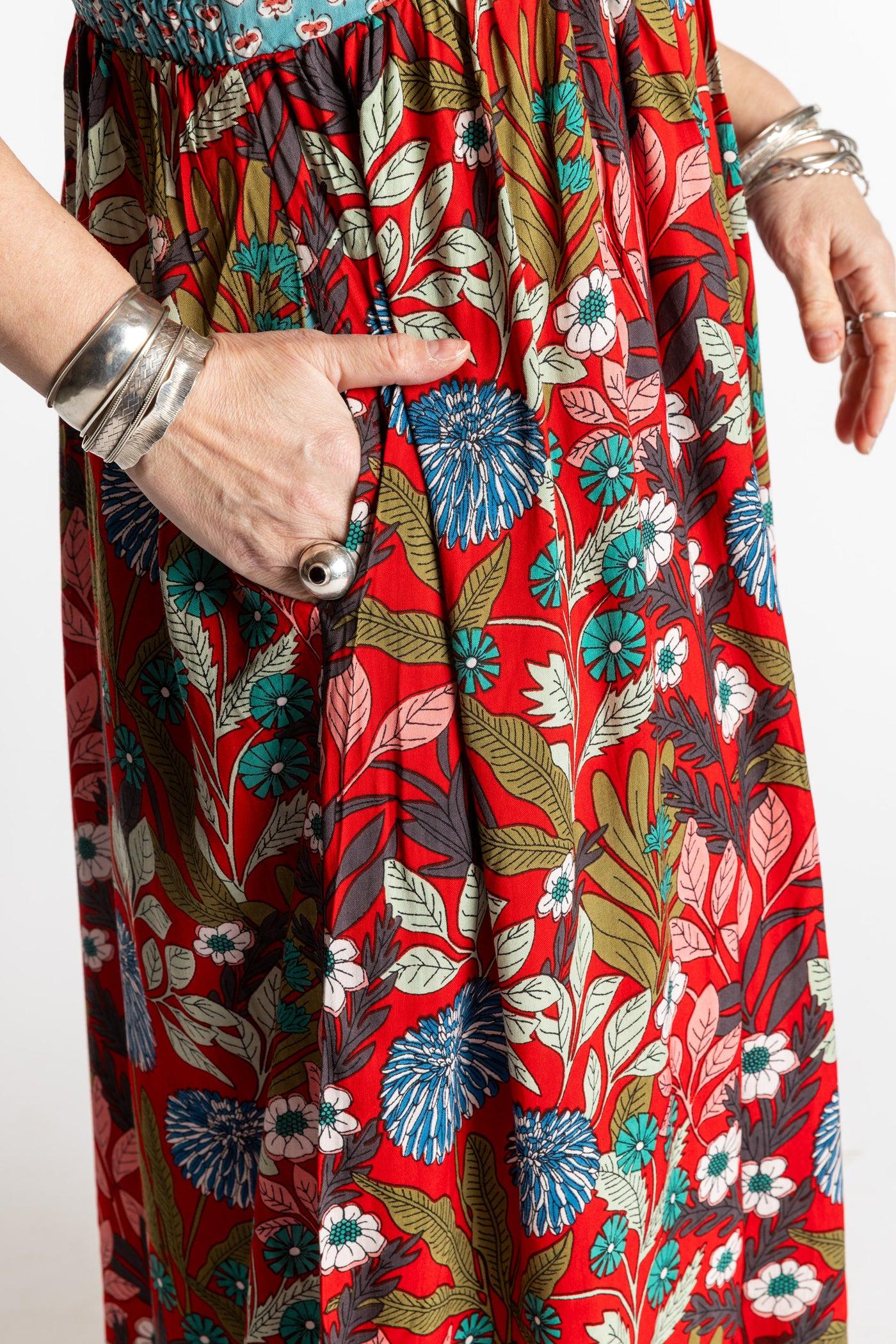 Susan wearing size M/L red floral Flora Fusion maxi dress with teal contrast top 