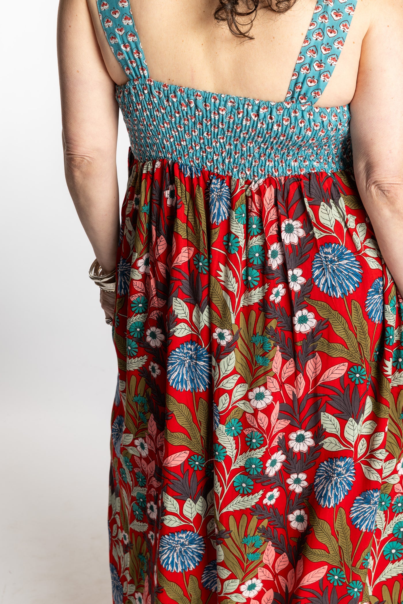 Susan wearing size M/L red floral Flora Fusion maxi dress with teal contrast top 
