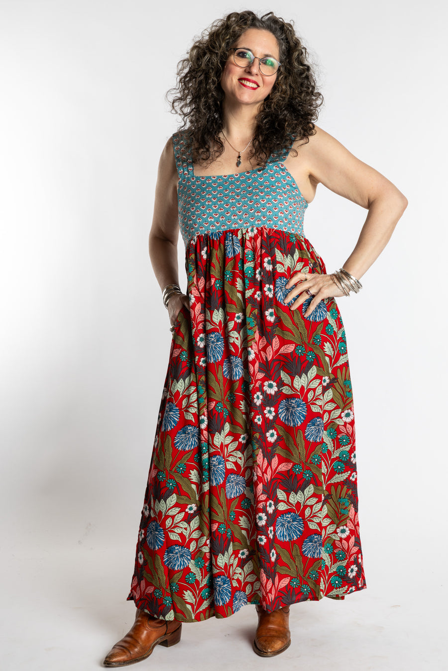 Susan wearing size M/L red floral Flora Fusion maxi dress with teal contrast top 