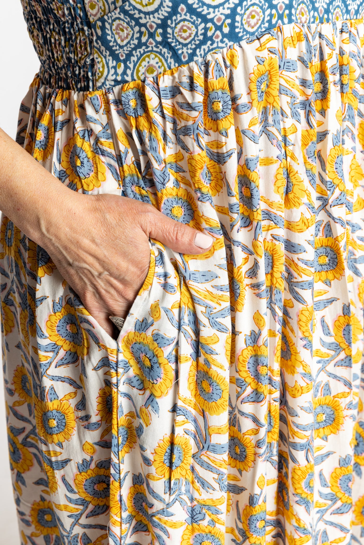 Betty wearing the L/XL Sunflower floral Flora Fusion maxi dress with smocked bodice and flowy skirt