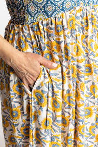 Betty wearing the L/XL Sunflower floral Flora Fusion maxi dress with smocked bodice and flowy skirt