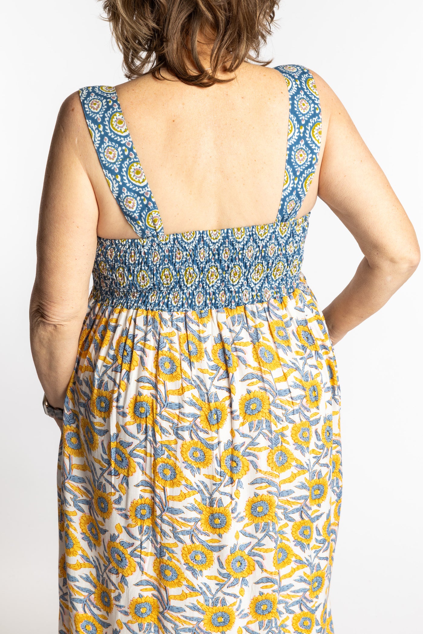 Betty wearing the L/XL Sunflower floral Flora Fusion maxi dress with smocked bodice and flowy skirt
