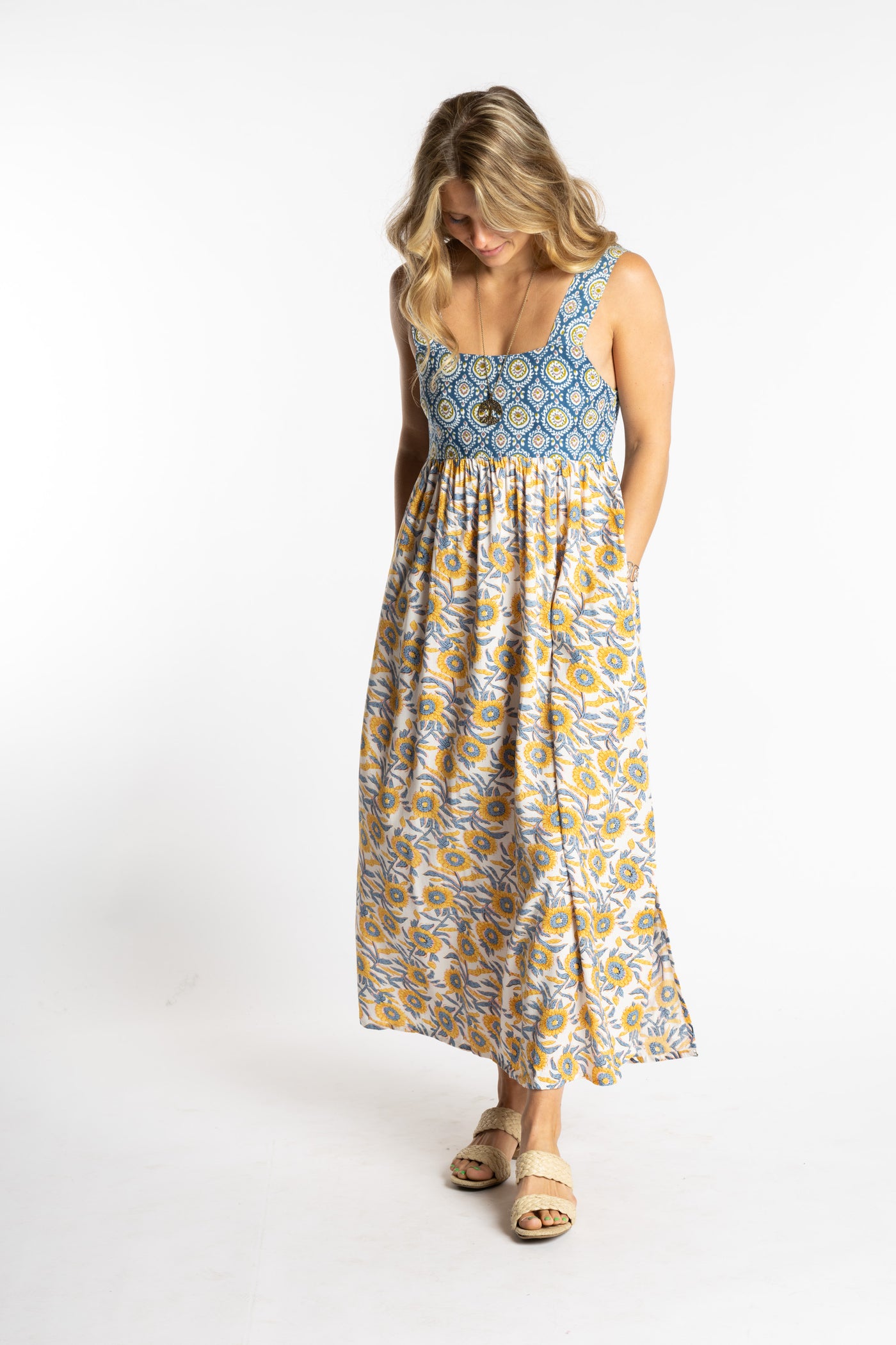 Sophie wearing the S/M Sunflower floral Flora Fusion maxi dress with smocked bodice and flowy skirt