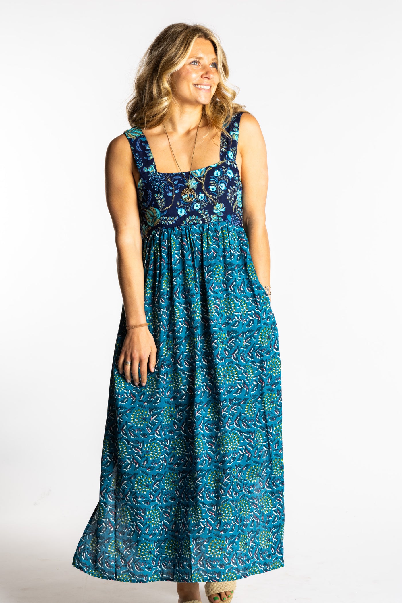 Sophie wearing the S/M teal floral Flora Fusion maxi dress with smocked bodice and flowy skirt