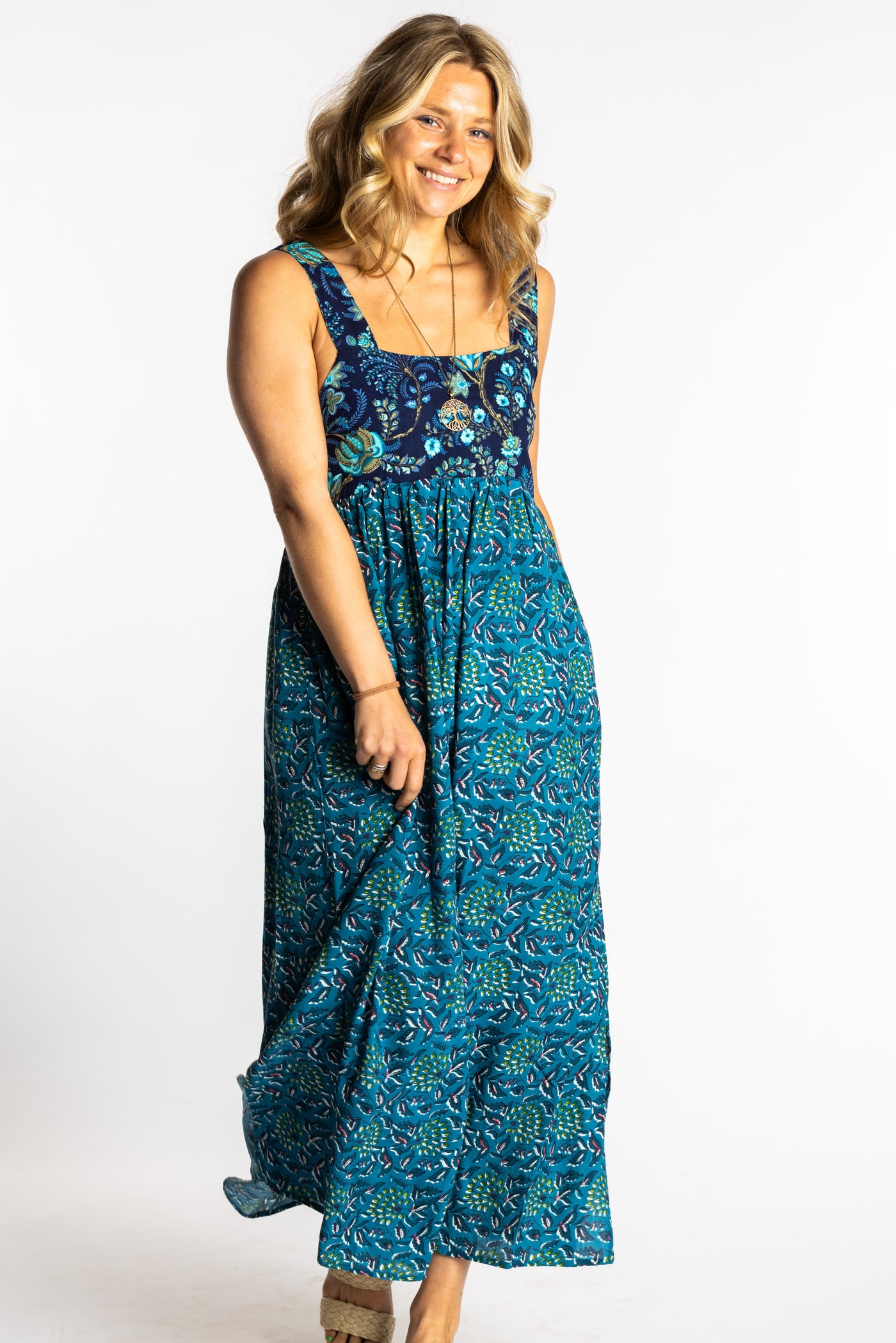 Sophie wearing the S/M teal floral Flora Fusion maxi dress with smocked bodice and flowy skirt