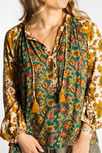 Sophie is wearing the mixed print forest green boho floral poet blouse top
