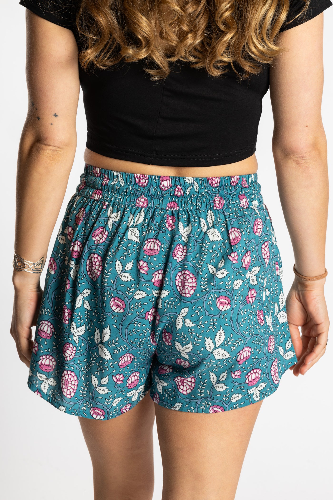 Sophie wearing the size S/M Summer Solstice Shorts in aquamarine blue floral print with relaxed boho fit