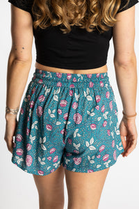 Sophie wearing the size S/M Summer Solstice Shorts in aquamarine blue floral print with relaxed boho fit