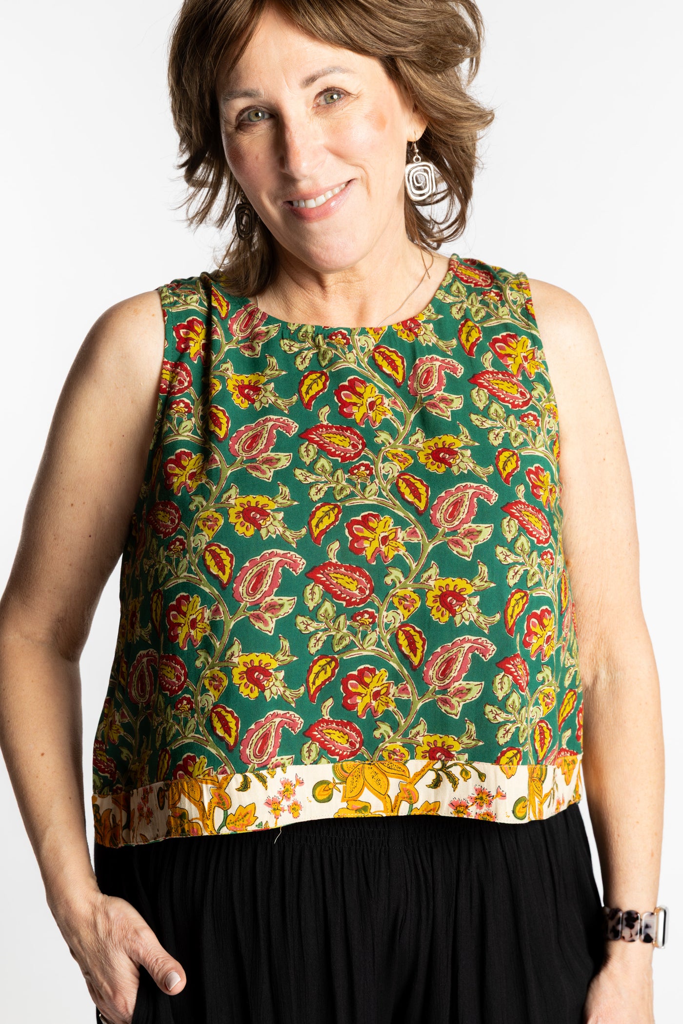 Betty wearing size L/XL Sahana Contrast Hem Sleeveless Top in Forest Green floral print flowy boho sleeveless top