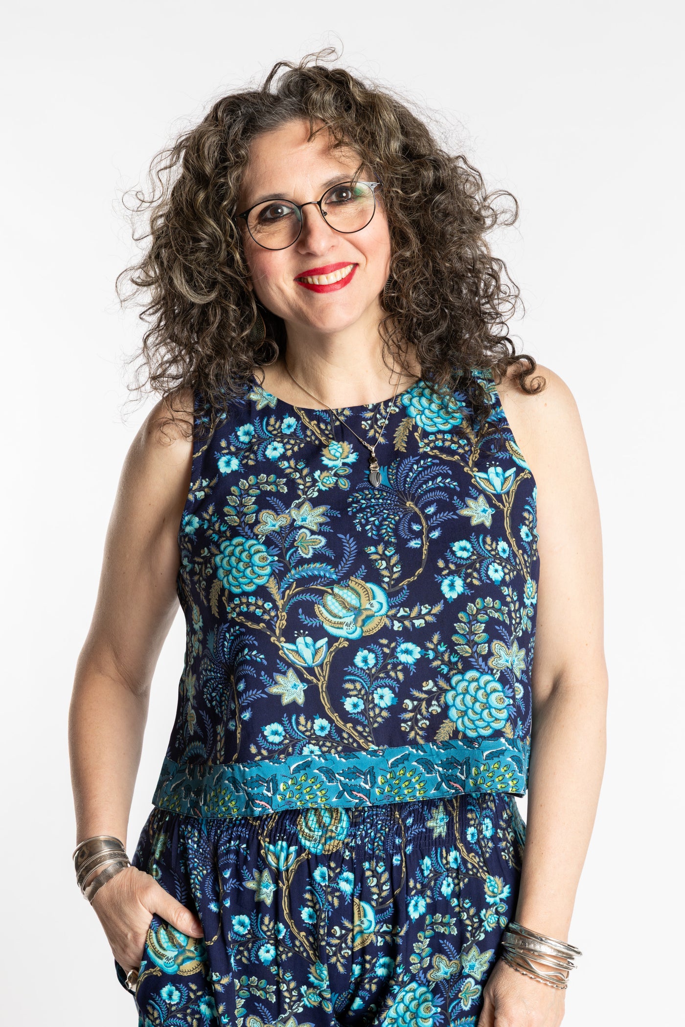 Susan wearing size M/L Sahana Contrast Hem Sleeveless Top in Navy blue floral print flowy boho sleeveless top