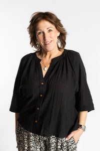 Betty is wearing the L/XL black flowy boho cotton top