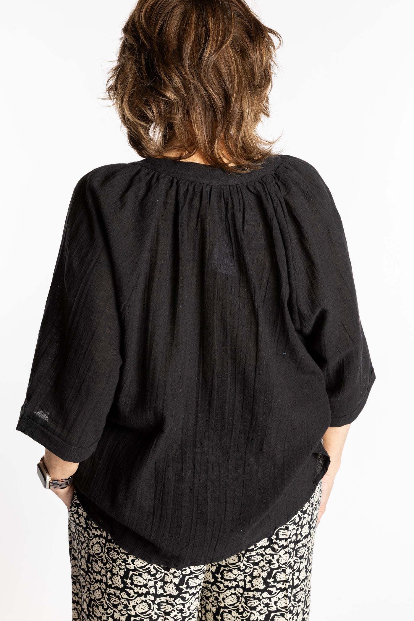 Betty is wearing the L/XL black flowy boho cotton top