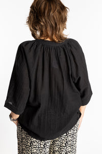 Betty is wearing the L/XL black flowy boho cotton top