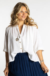 Sophie is wearing the S/M white flowy boho cotton top