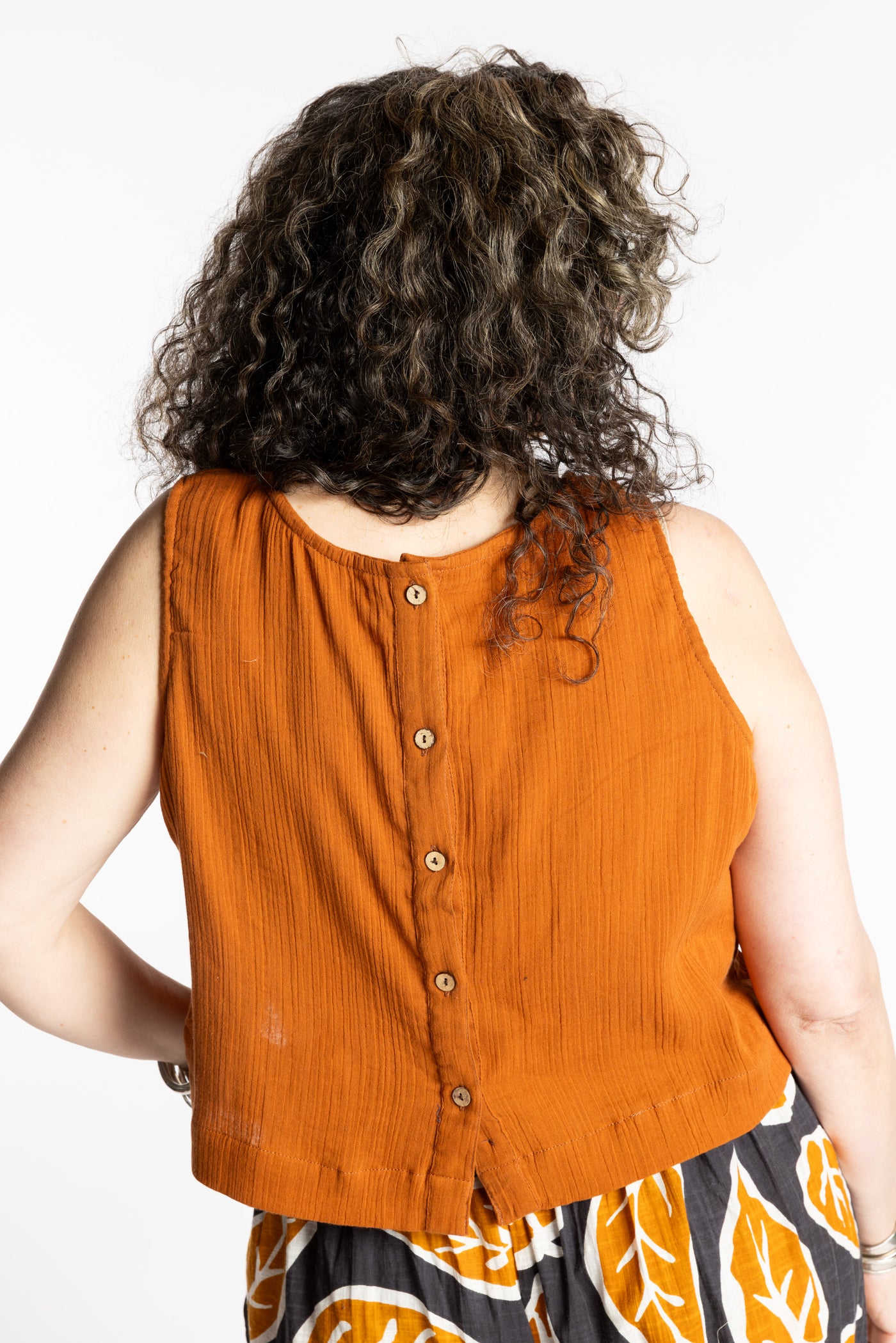 Susan wearing M/L rust sleeveless cotton top with textured fabric and relaxed fit