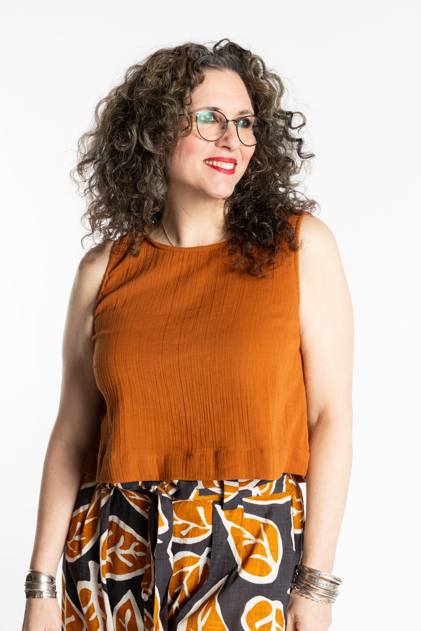 Susan wearing M/L rust sleeveless cotton top with textured fabric and relaxed fit